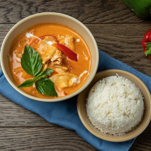 Bai Tong Thai red curry with chicken, bell peppers, and basil, served with white rice.